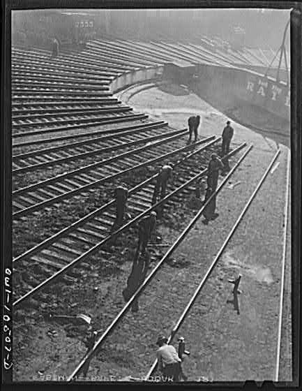 Chicago, Illinois. A maintenance crew repairing tracks in the roundhouse at an