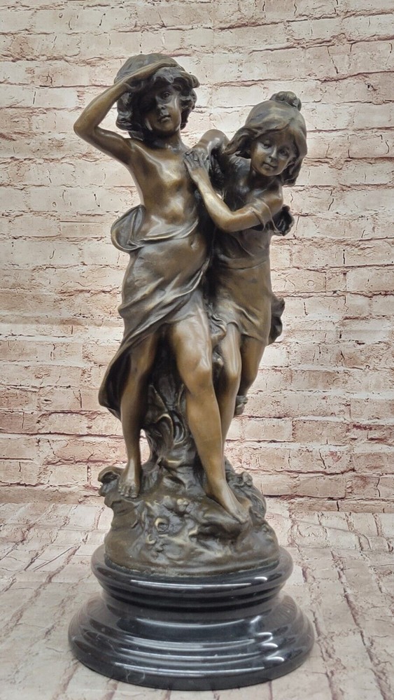 Bronze brother and sister pair. A girl and a boy run arm in arm along Sculpture