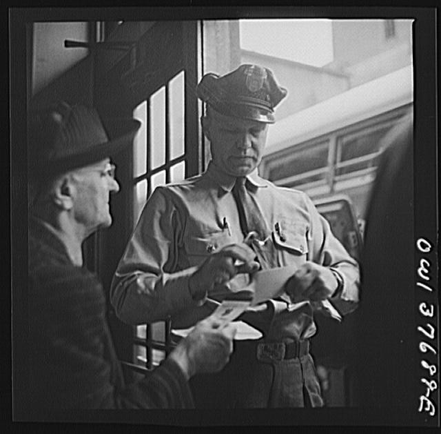 Photo:Untitled photo, Illinois. A bus driver punching tickets, : Chicago