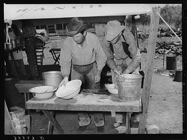 Cowboys of the SMS Ranch washing up for dinner. Ranch near Spur, Texas