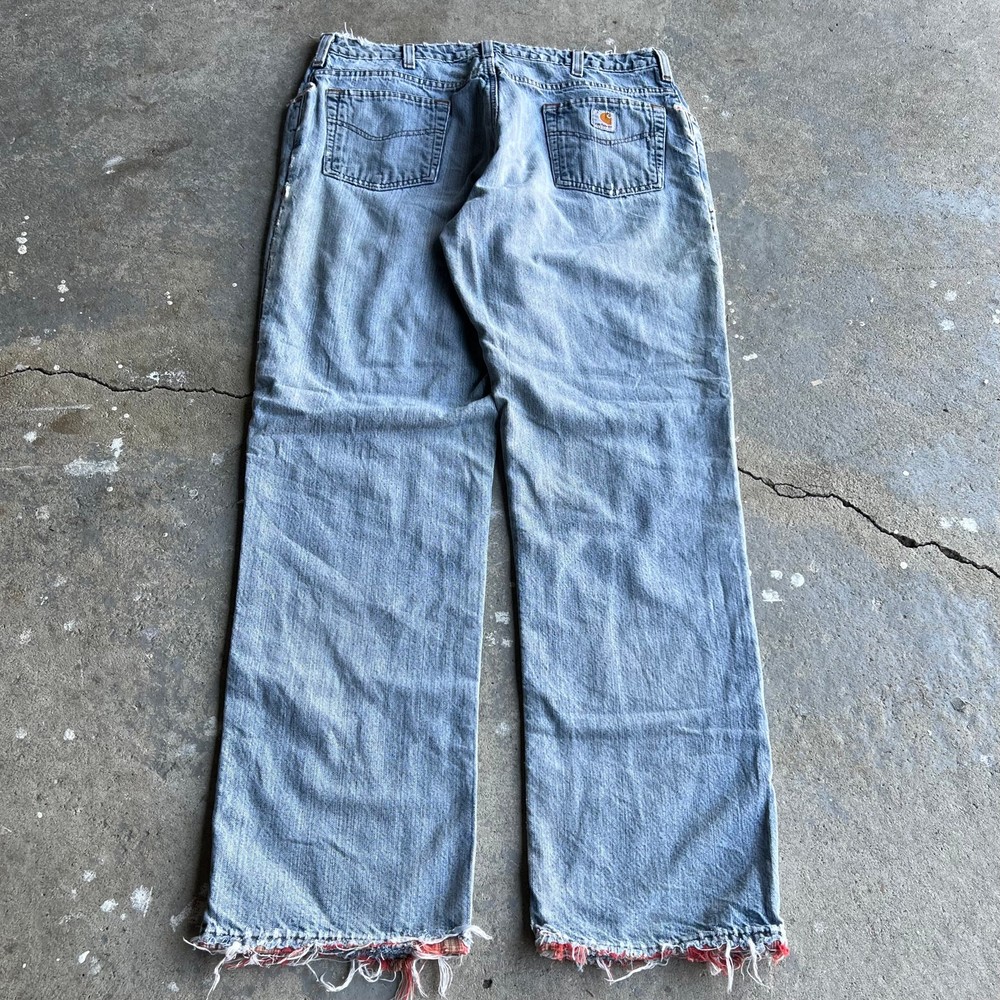 Vintage Carhartt flannel-lined denim carpenter jeans in blue workwear
