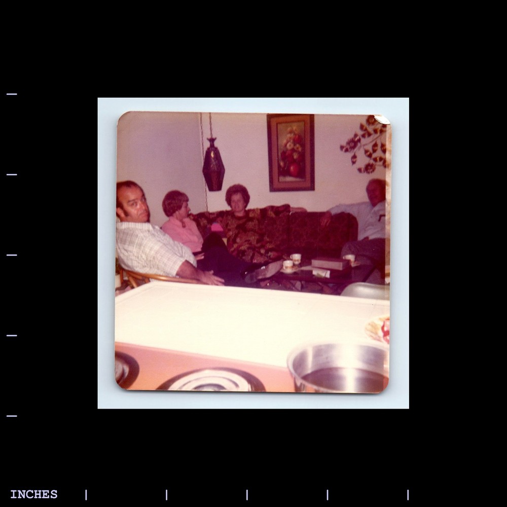 Square Color Photo MEN AND WOMEN SITTING IN LIVING ROOM