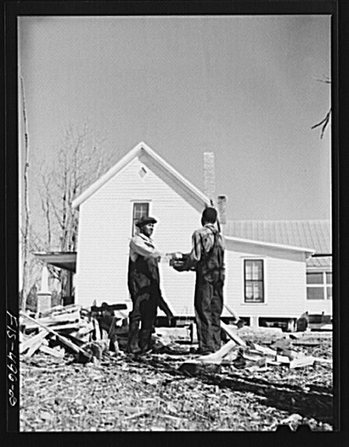 Photo:North Carolina. Feggen Jones and his son at the woodpile, Zebulon