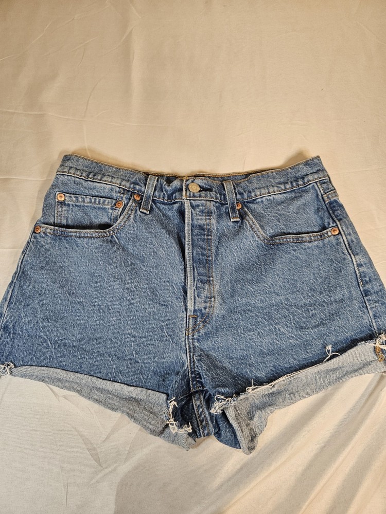 Levi's 501 high-waisted denim button-fly shorts with a distressed raw hem.  Size