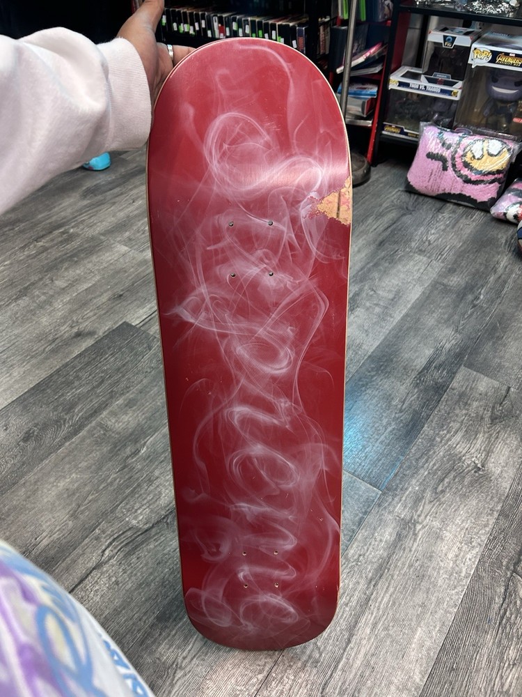 This is a Supreme Smoke Skateboard Deck in red