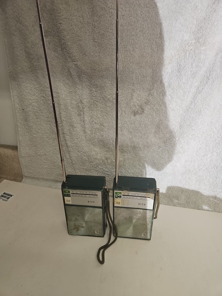 Vintage Afco AM/FM solid-state portable transistor radios, likely from the 1960s