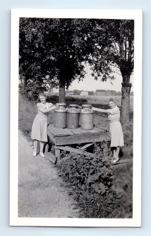 Old Vintage Photo PAIR LEGGY WOMEN COLLECTING MILK JUGS ON FARM SNAPSHOT 1943