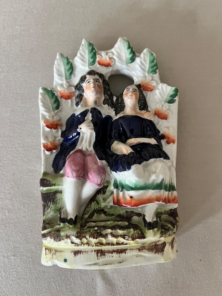 Staffordshire man & woman on bench