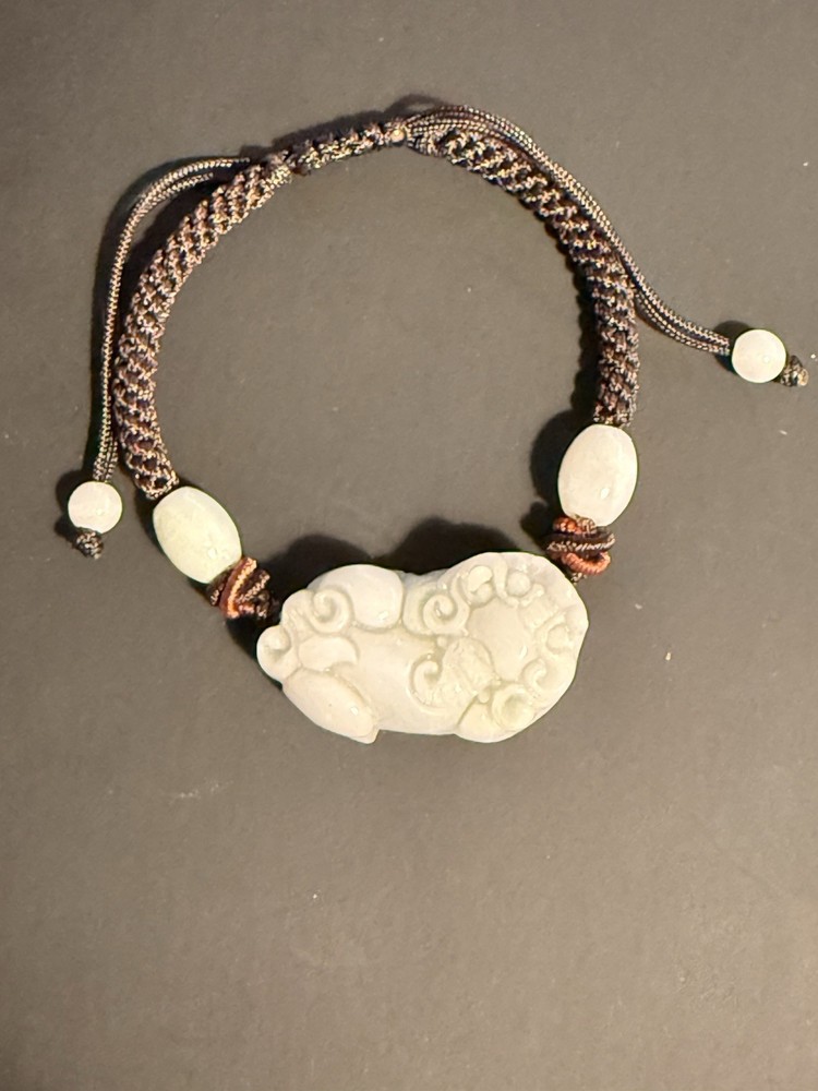 This is a Jadeite Pixiu Bracelet with an Adjustable Braided Rope Cord.