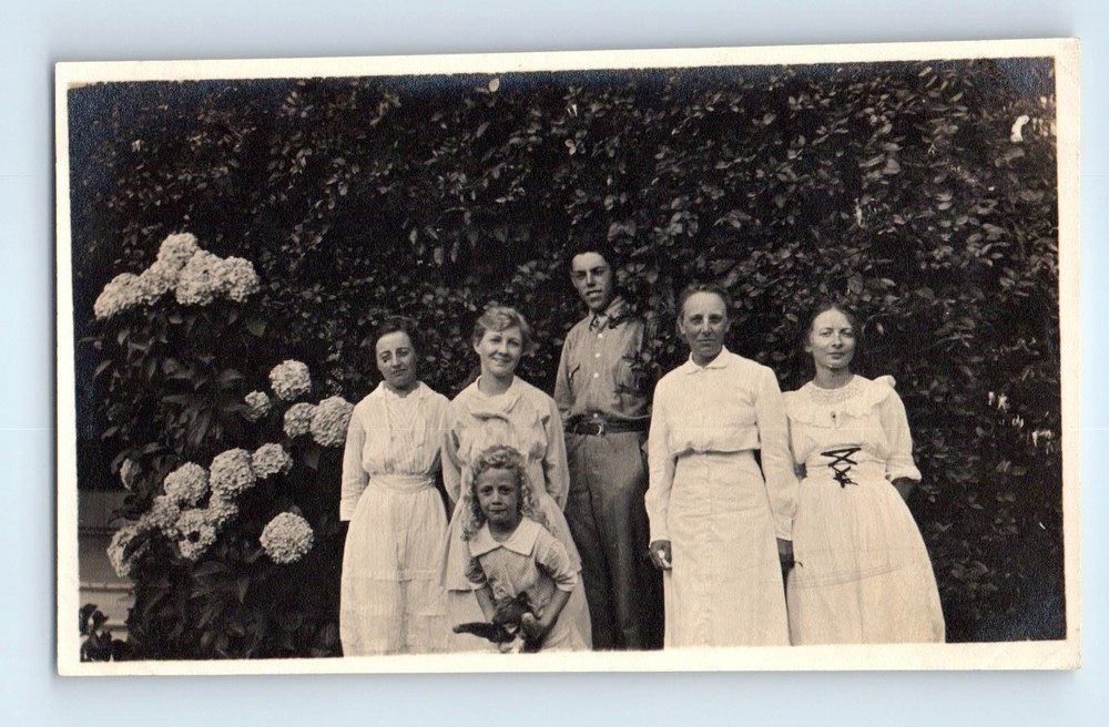 Old Vintage Photo MAN WOMEN AND GIRL STANDING BY FLOWERS PUPPY DOG SNAPSHOT