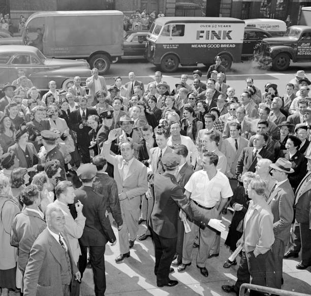 Film tough guy Humphrey Bogart is surrounded by throng with bobby  .. Old Photo