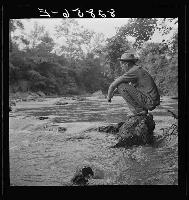 Photo:Man on Rock by River 1930s Outdoors Woodland Scene