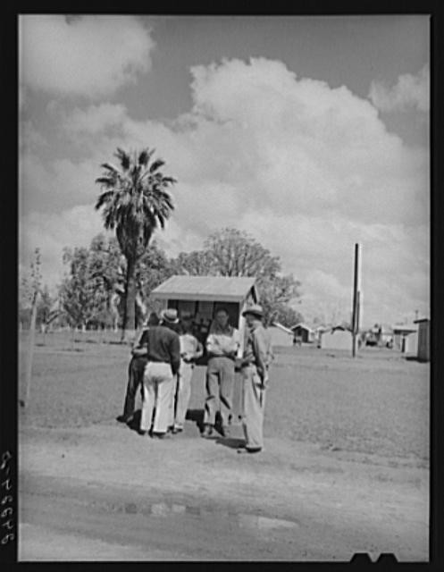 Photo:Visalia California 1940 Tulare Migrant Camp Men Bulletin Board