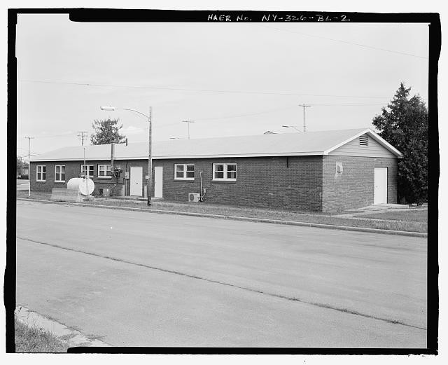 NORTHWEST (REAR) AND SOUTHWEST (SIDE) ELEVATIONS OF BUILDING view TO EAST. -