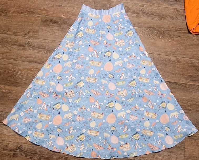 Light blue a line skirt with fun pattern of cartoon characters in size Small