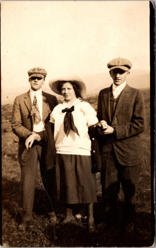 Vintage RPPC Postcard Young Men in Dark Suits Hat Tie Hold Woman by Wrists 23167