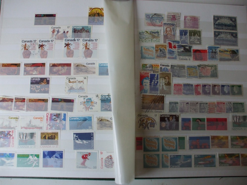 AN ALBUM/STOCKBOOK MINT AND USED CANADA,PLENTY OF STAMPS  IN A USEFUI ALBUM