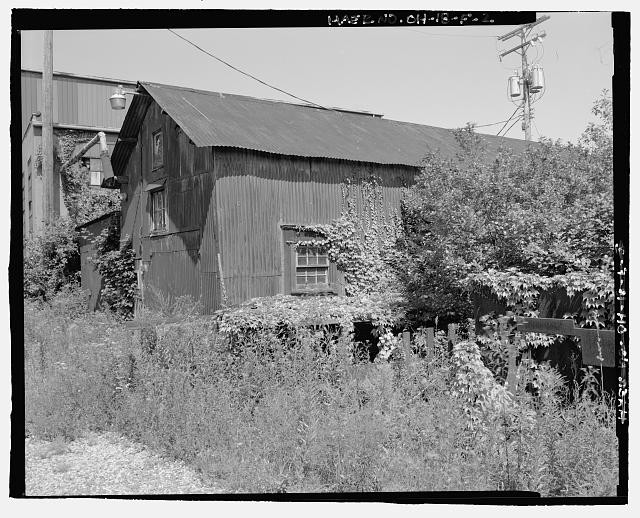 OBLIQUE VIEW OF WEST FAÇADE AND SOUTH ELEVATION. LOOKING NORTHEAST. -