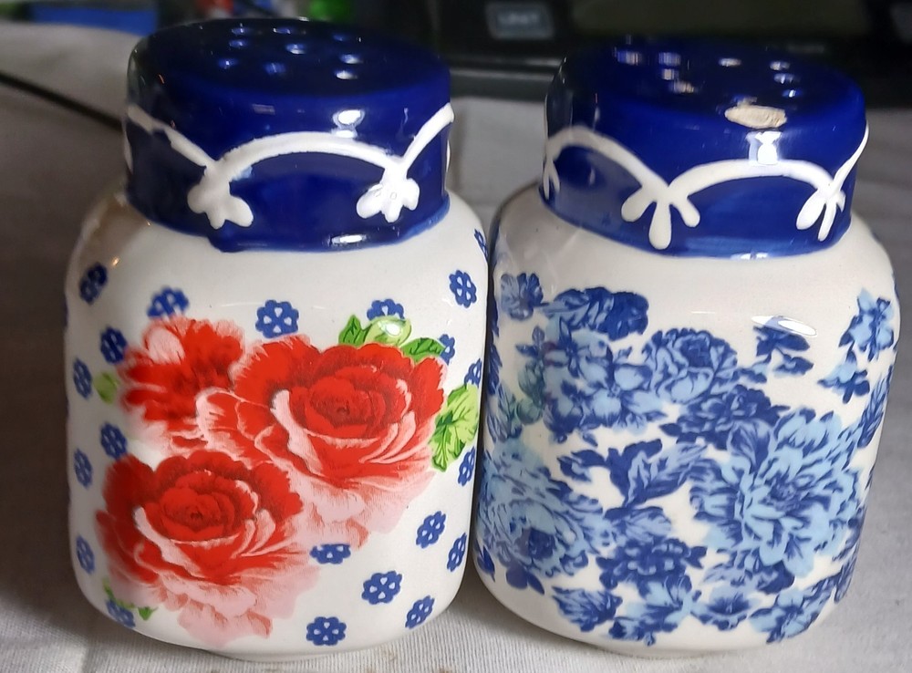 the pioneer woman salt and pepper shakers With Floral Pattern On One And Blue...Blue chipped on top see pictures
