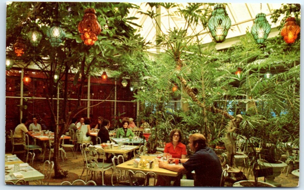 Patio dining amid a tropical indoor garden, Kapok Tree Inn - Clearwater, Florida
