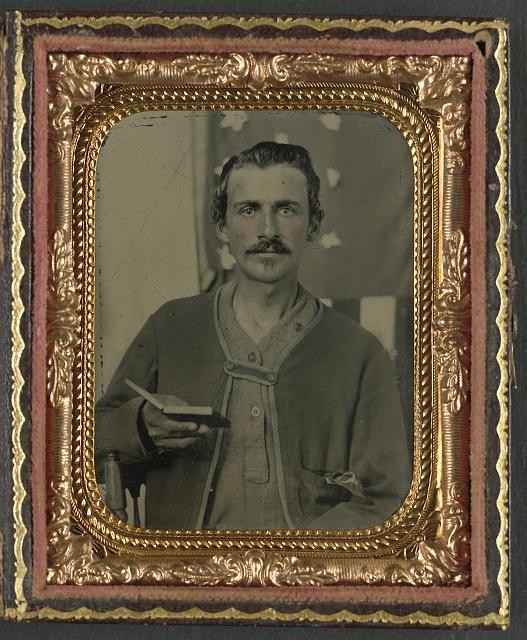 Unidentified soldier in Union Zouave uniform with cased photograph in front of