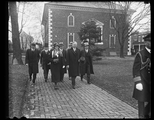 Photo:[Lou Hoover and Herbert Hoover strolling with group]