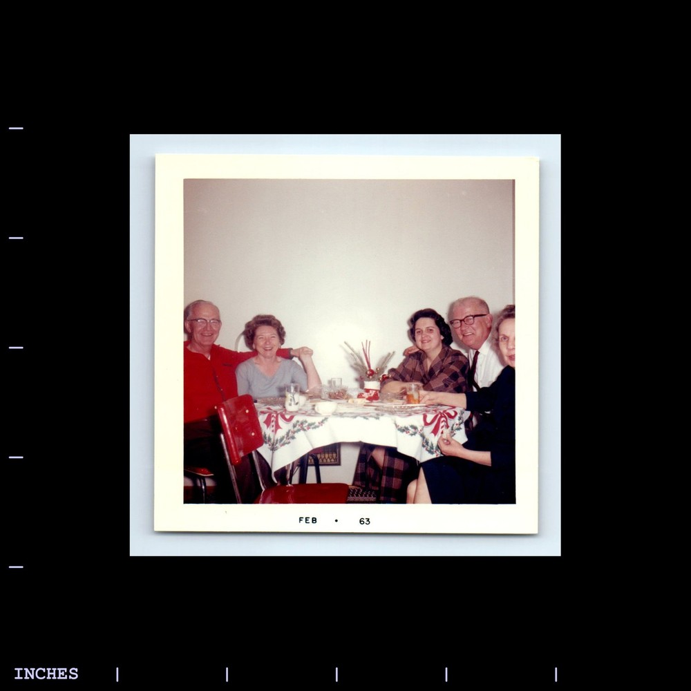 Square Color Photo AFFECTIONATE MEN WOMEN SITTING AT DINNER TABLE 1963