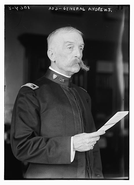Photo:Adj. Gen. Andrews holding sheet of paper