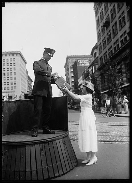 Photo:New York City 1910s Mailman Woman Letter Exchange Street Scene
