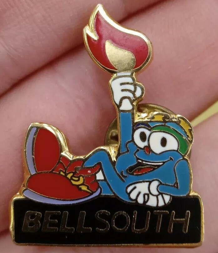 Marked 1993. BellSouth Atlanta Olympics Mascot Holding Torch Lapel Pin