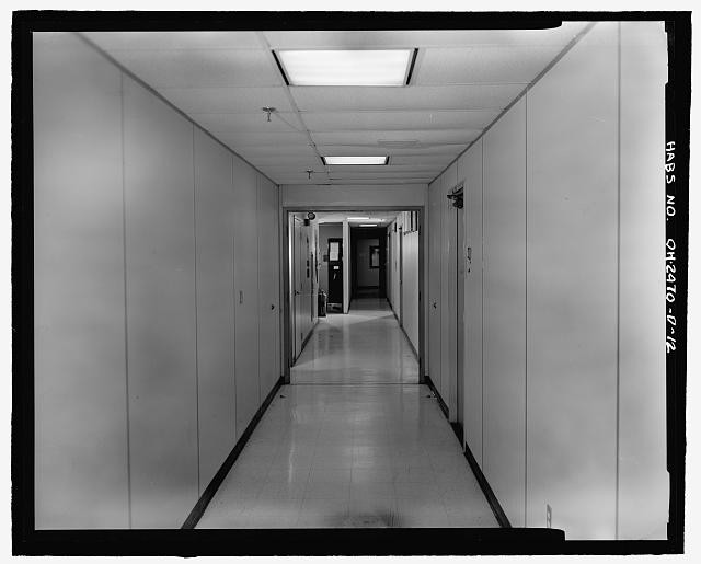 A corridor on the first floor of the building, looking west, shows some of the