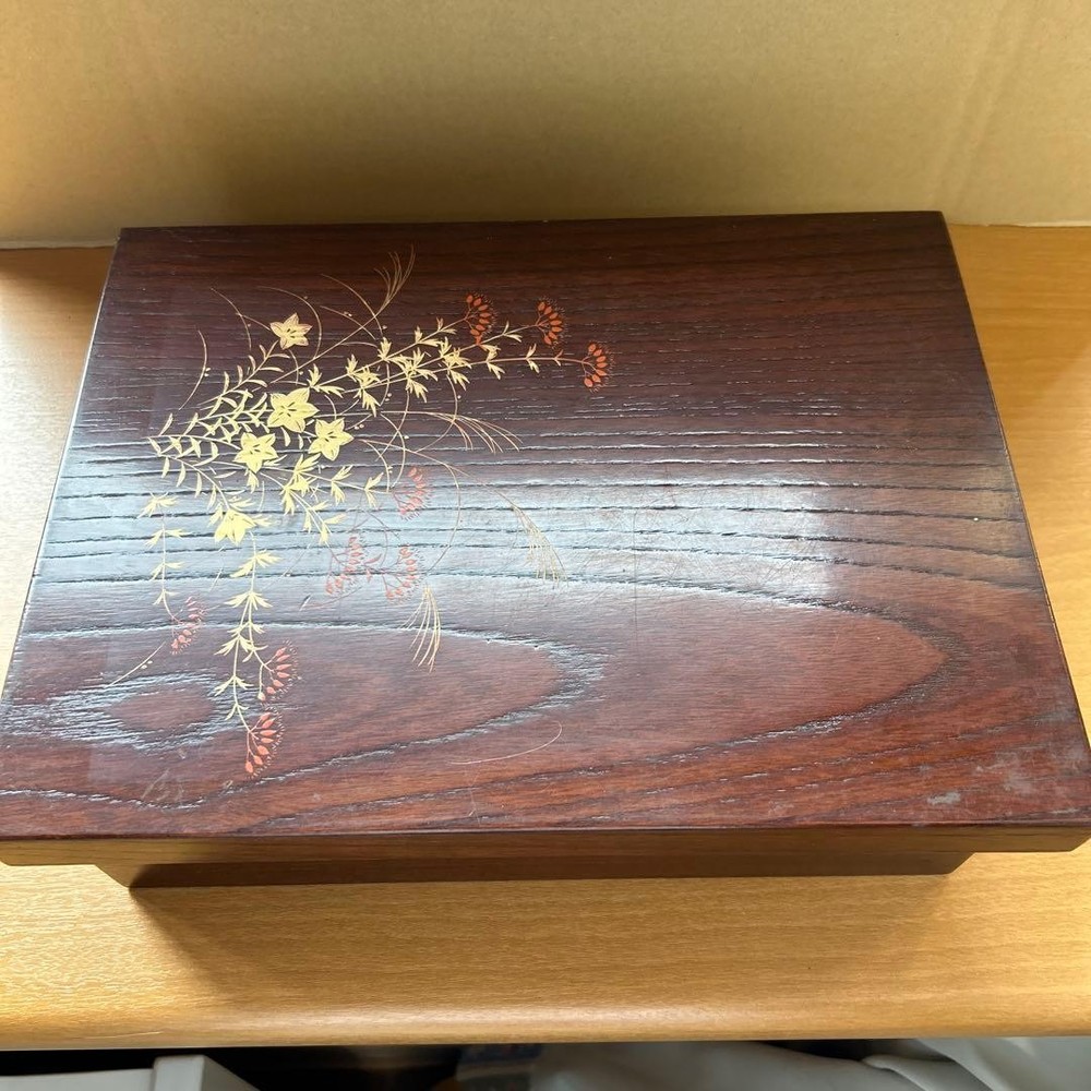Wooden long box with gold and red floral pattern, red interior