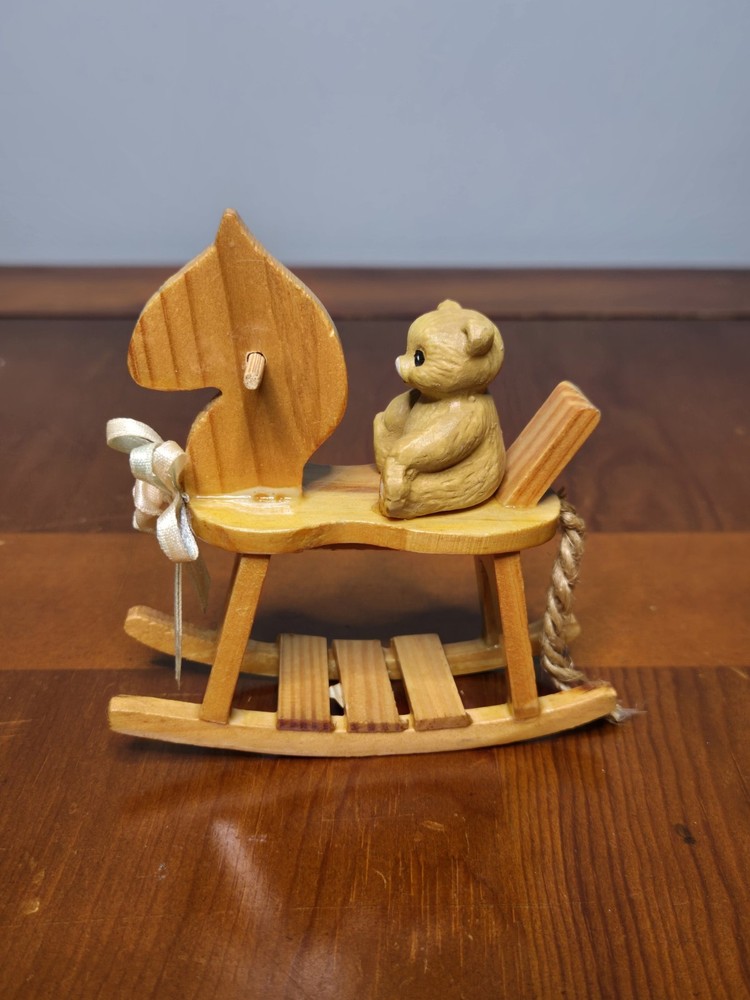 vintage wooden rocking horse figurine with a small resin teddy bear