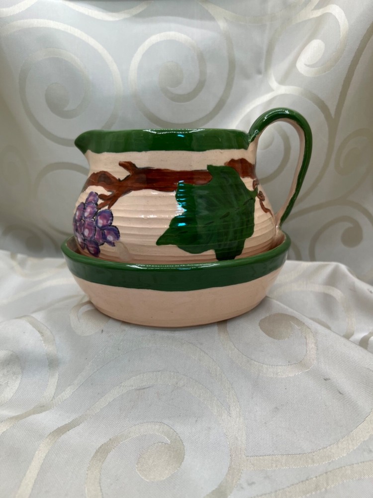 Handthrown pottery pitcher and plate, grapes and leaves