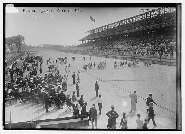 Plolice Show -- Chariot Race,race track,spectators,American flag,Bain News