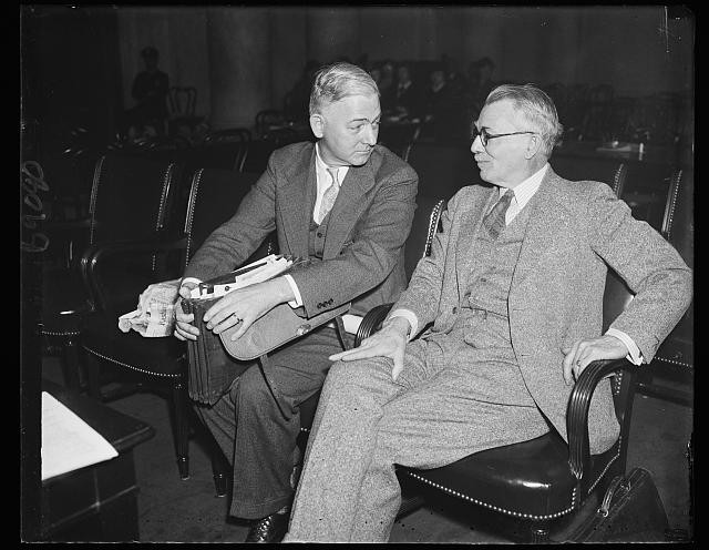Photo:1940s Two Men in Suits Seated in Meeting Room Black and White Photo