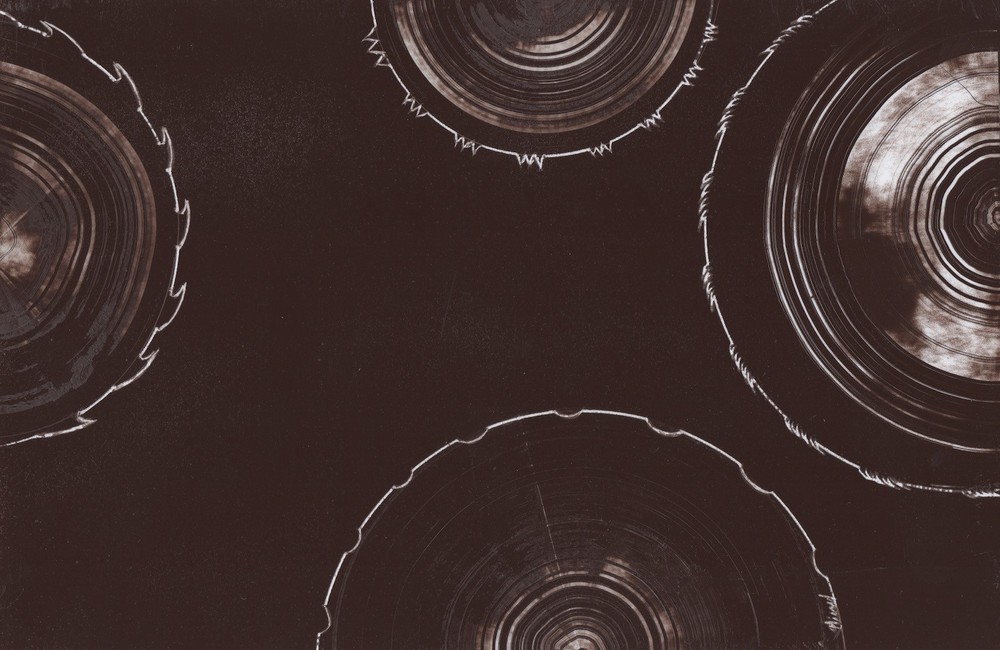 Circular Saw blade Art in Brown signed by artist Jason Girard in a small size.