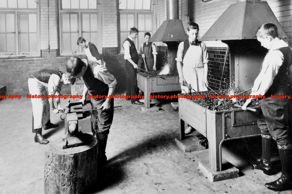 F001645 Boys using forges in a blacksmiths shop Beaufoy Institute London 1911