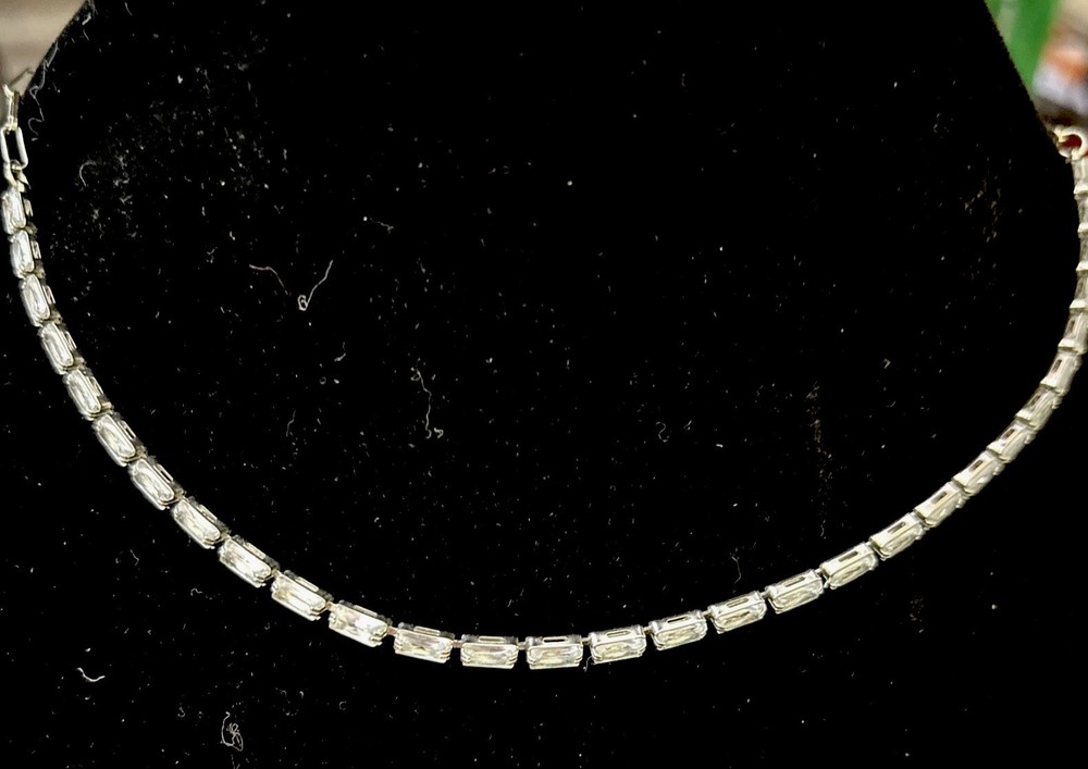 choker necklace featuring clear baguette rhinestones in a silver-tone setting.