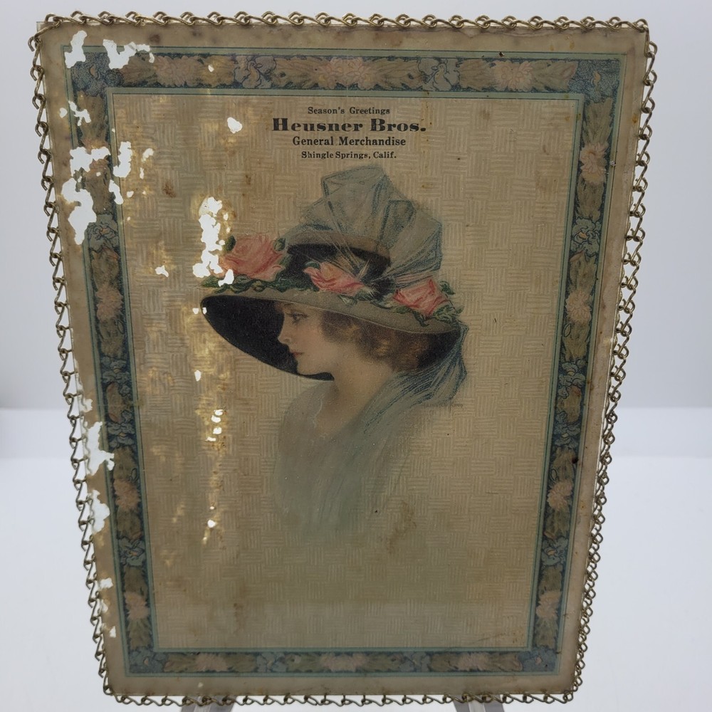 1918 Lady in Big Hat Advertisement Seasons Greetings Heusner Bros. Store