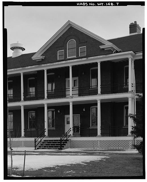 7. Detail north front building, showing veranda center cross gable. View south.