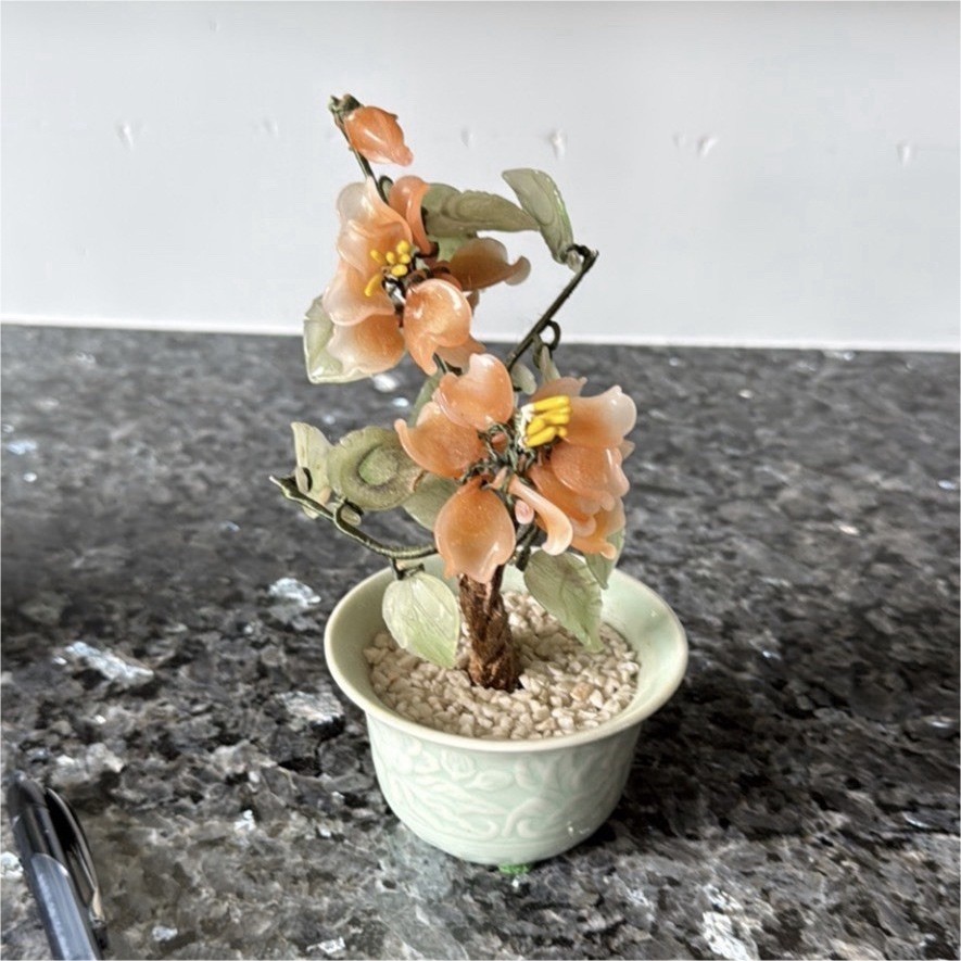 Jade glass bonsai tree with peach blossom flowers in celadon ceramic pot