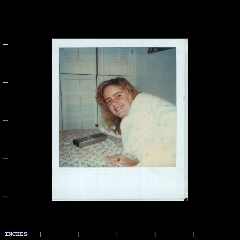 Old Polaroid Photo CLOSE-UP OF WOMAN WITH TV REMOTE CONTROL