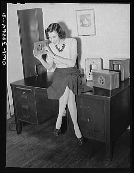 Photo:1930s Woman Listening to Tabletop Radio in Home Office