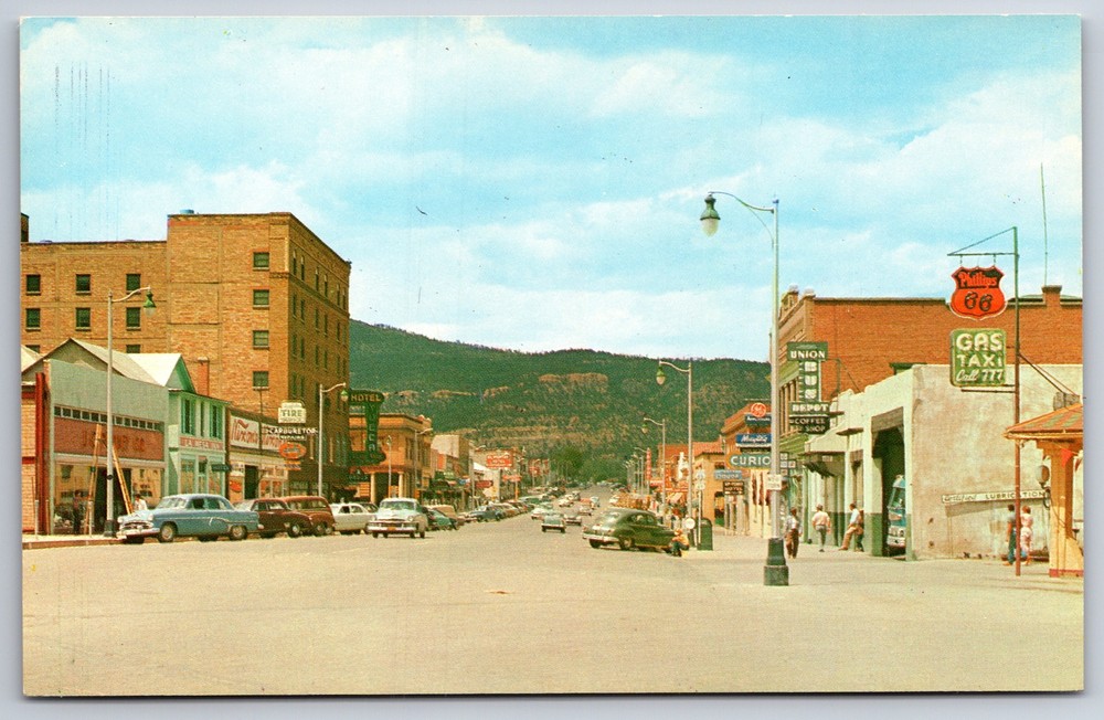 Raton New Mexico~Main Street~Phillips 66 Gas Station~1950s Postcard