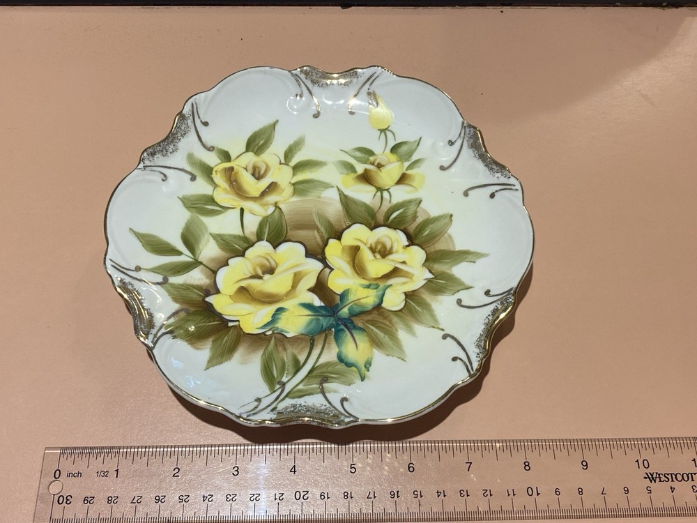 Vintage 8” porcelain plate with yellow flowers and gold trim.