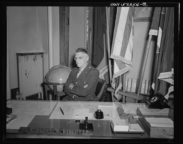 Photo:Military Officer at Desk with Flags 1930s 1940s Portrait