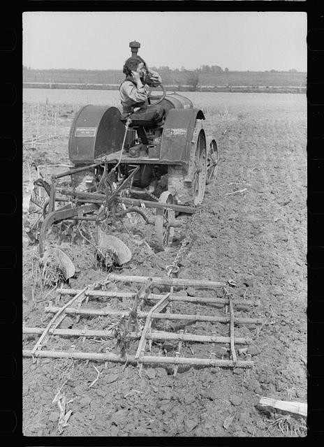 Photo:Grant County Illinois 1940 FSA Farm Tractor Plowing Field with Calf