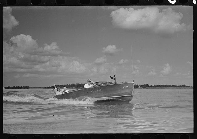 Photo:1930s Motor Boat on Water with Passengers and Flag