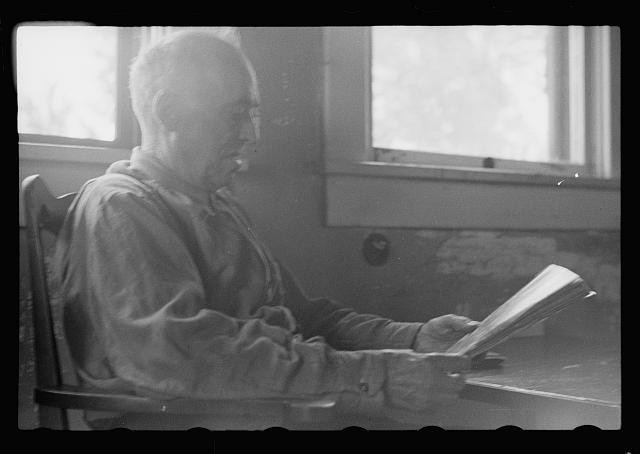 Photo:1930s Elderly Man Reading by Window Interior Black White Portrait